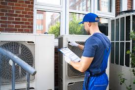 HVAC technician servicing an air duct system