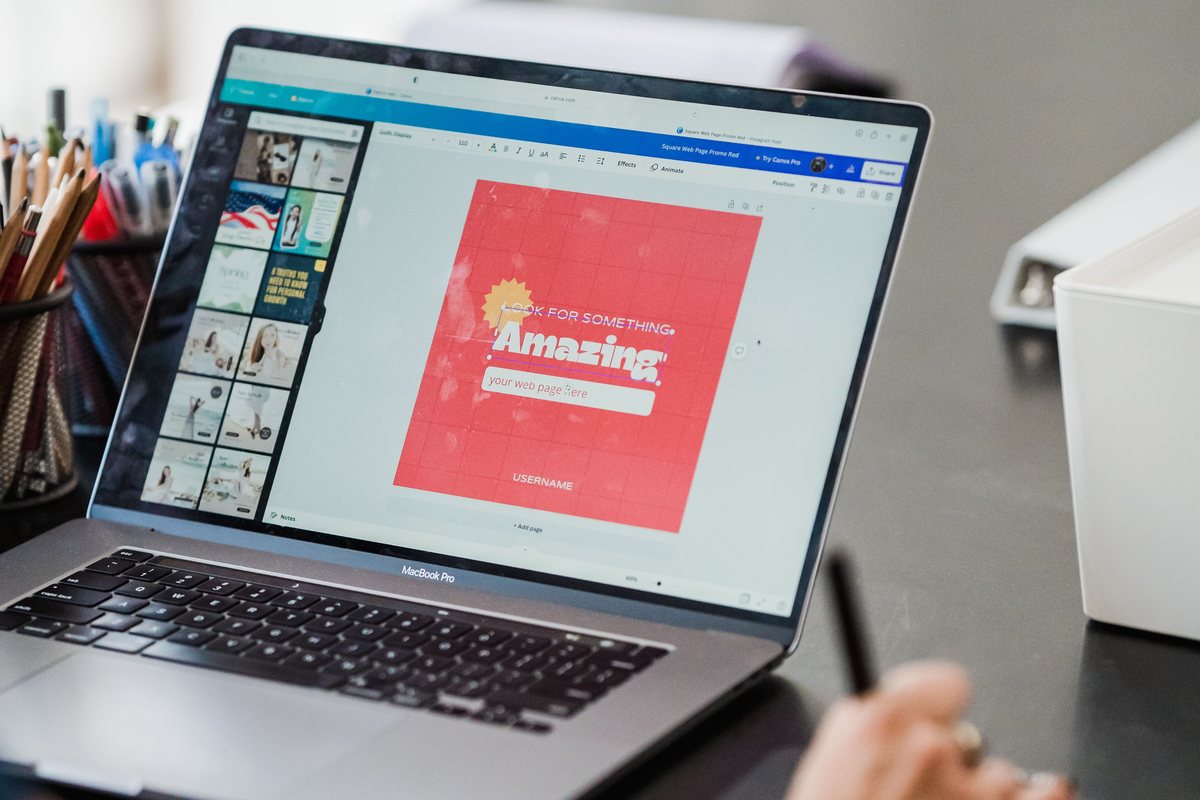 Designer working on branded graphics on a laptop